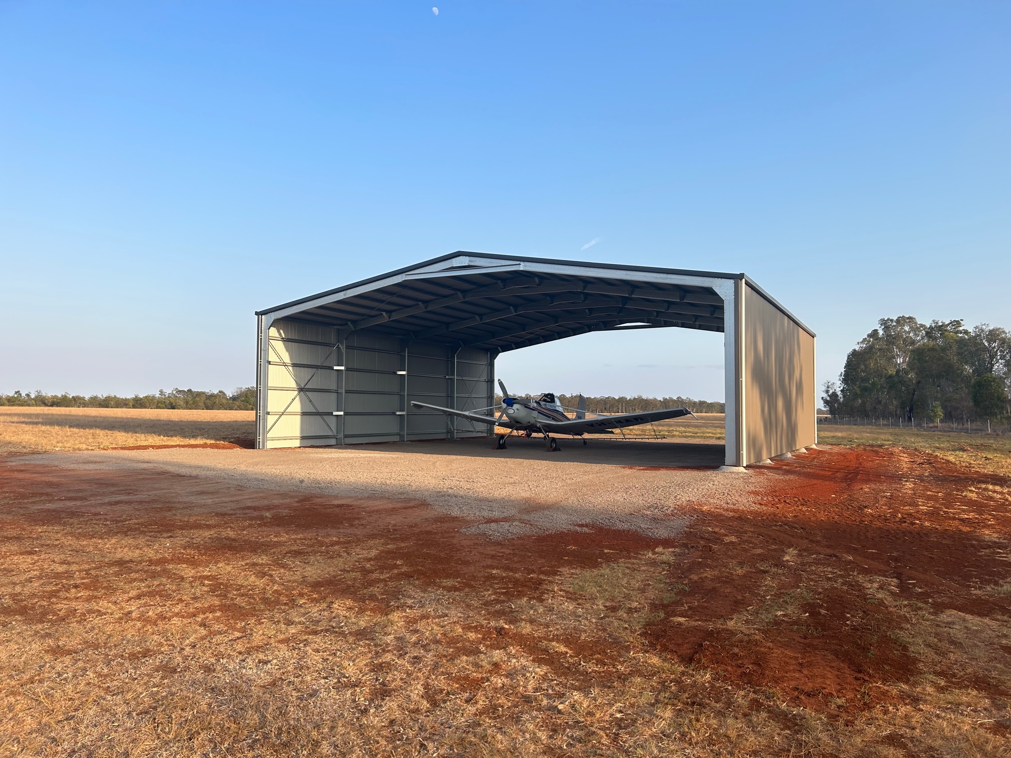 Now Buildings Drive-Thu shed with light air craft parked inside